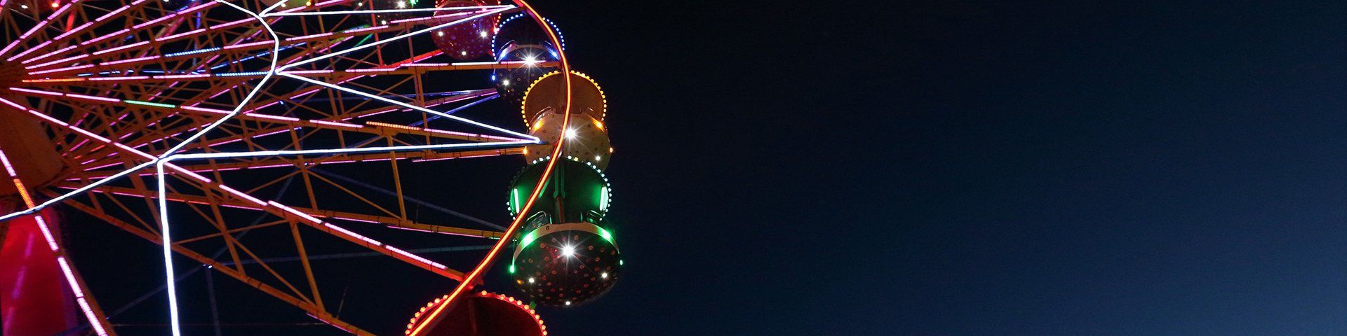 A ferris wheel illuminated against the night sky